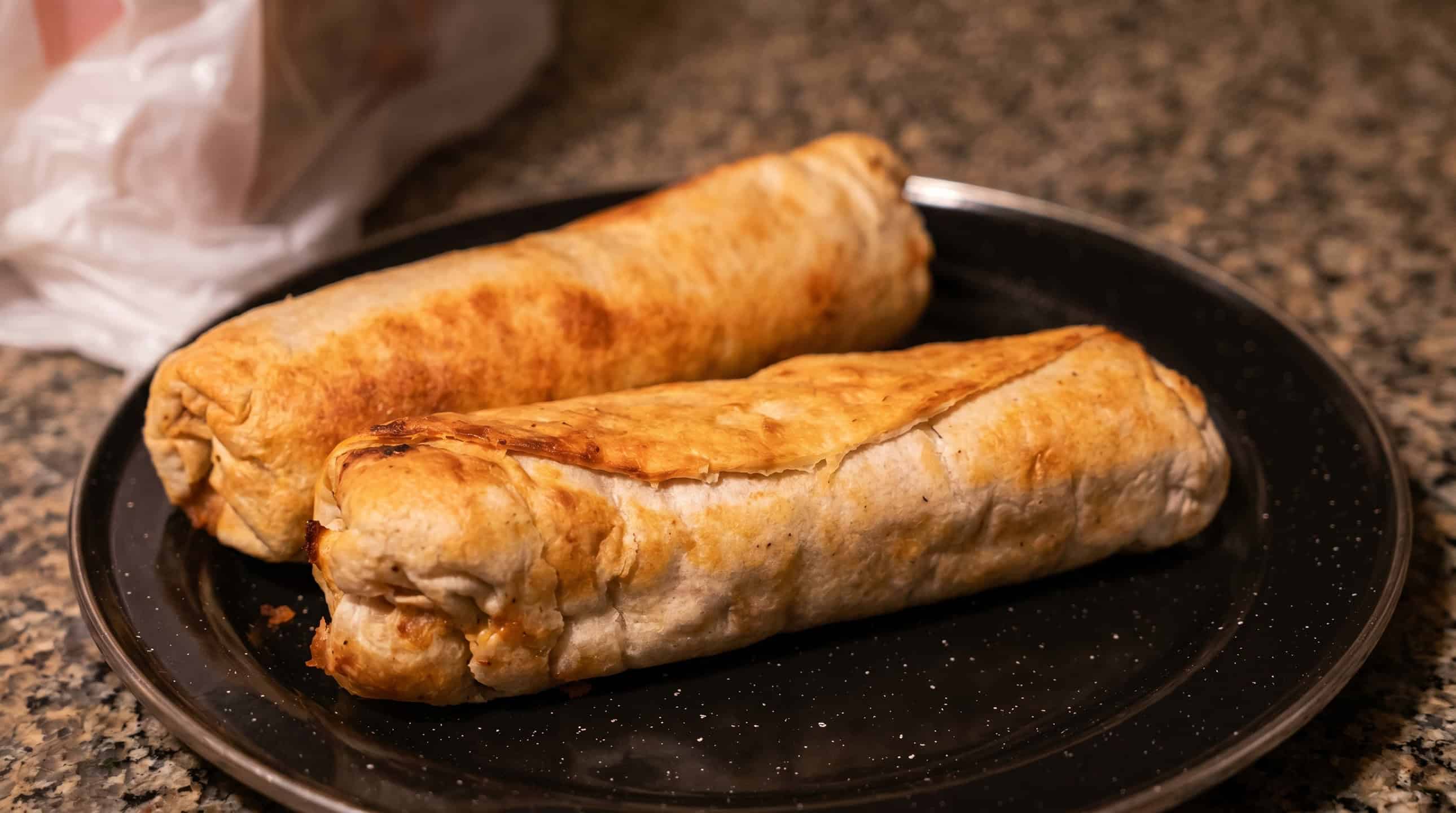 Golden, crispy chimichanga with sour cream and salsa