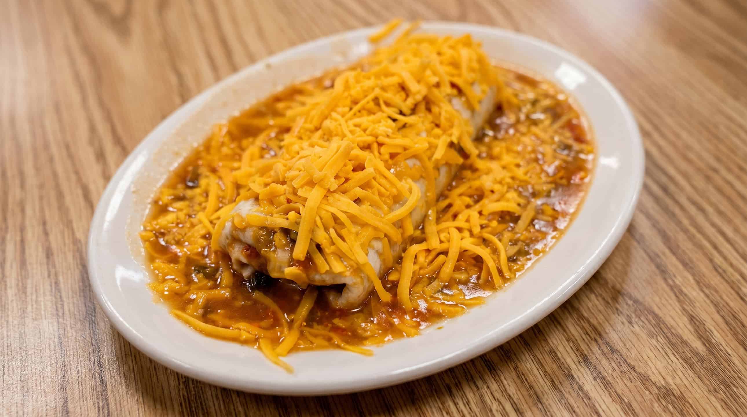 Smothered burrito covered in green chili and melted cheese